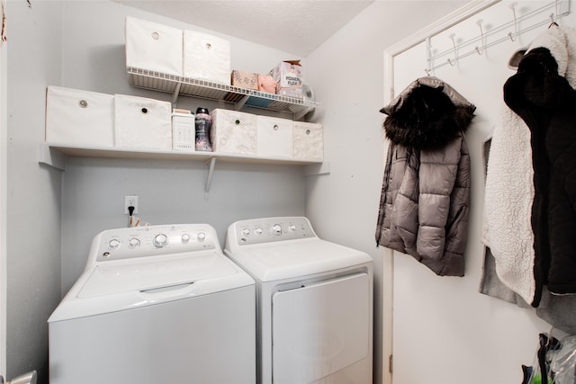 laundry area featuring separate washer and dryer and a textured ceiling