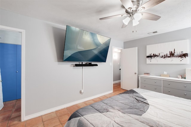 tiled bedroom featuring ceiling fan