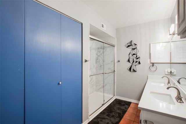 bathroom with vanity, an enclosed shower, and tile patterned flooring