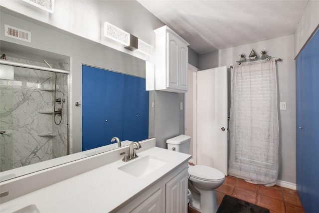 bathroom featuring vanity, walk in shower, tile patterned floors, and toilet