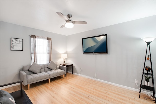 living room with ceiling fan and light hardwood / wood-style flooring