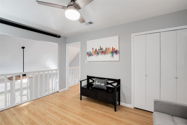 sitting room with ceiling fan and light hardwood / wood-style flooring