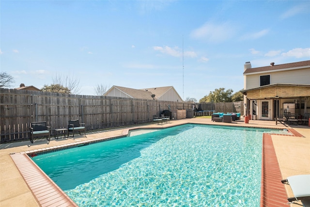 view of pool with an outdoor living space, a patio, and ceiling fan