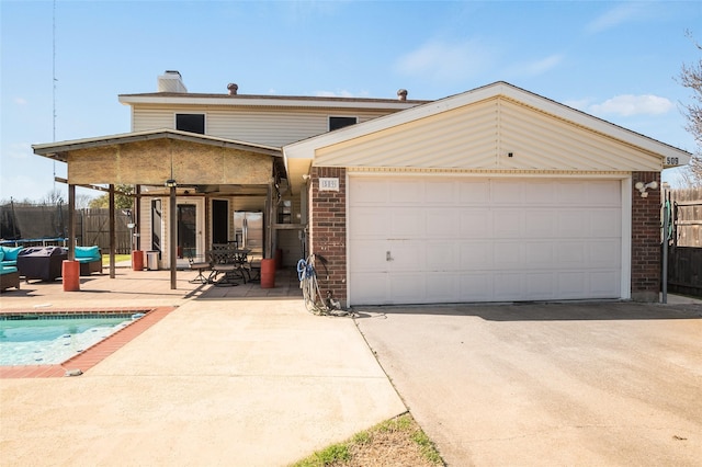 view of front of property with a fenced in pool, a patio, and a trampoline