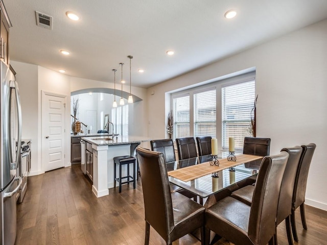 dining room with dark hardwood / wood-style floors and sink