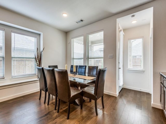 dining area with dark hardwood / wood-style flooring