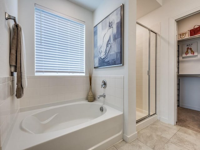 bathroom with tile patterned floors and independent shower and bath