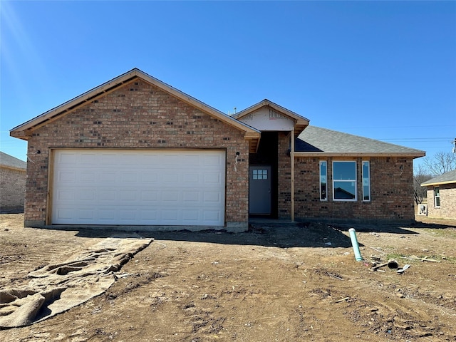 ranch-style home with brick siding and an attached garage