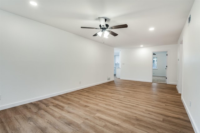 spare room featuring ceiling fan and light wood-type flooring