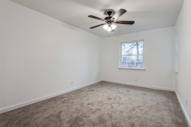 empty room with ceiling fan and carpet