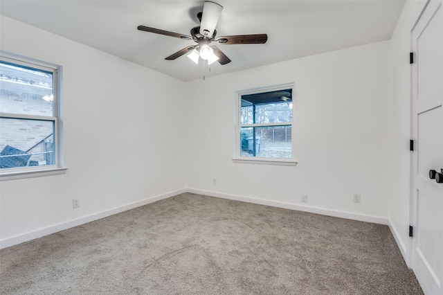 empty room featuring light colored carpet and ceiling fan