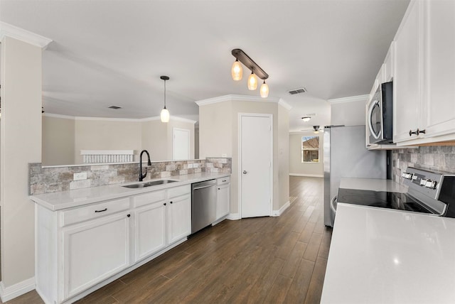 kitchen featuring appliances with stainless steel finishes, sink, hanging light fixtures, and white cabinets