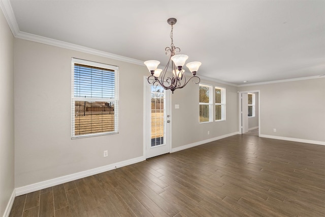 spare room featuring crown molding, dark wood-type flooring, and a healthy amount of sunlight