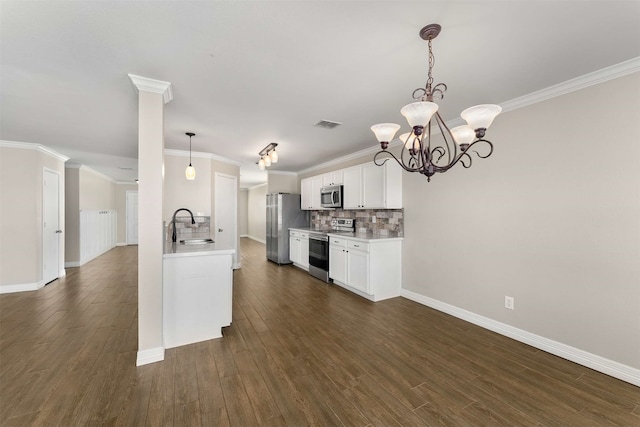 kitchen with sink, tasteful backsplash, hanging light fixtures, stainless steel appliances, and white cabinets