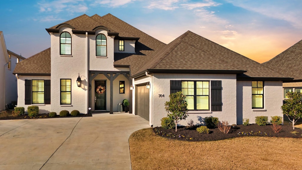 french provincial home with a garage