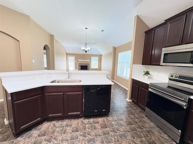 800 Warbler, Aubrey, TX 76227 - kitchen with stainless steel appliances, a sink, light countertops, dark brown cabinetry, and lofted ceiling