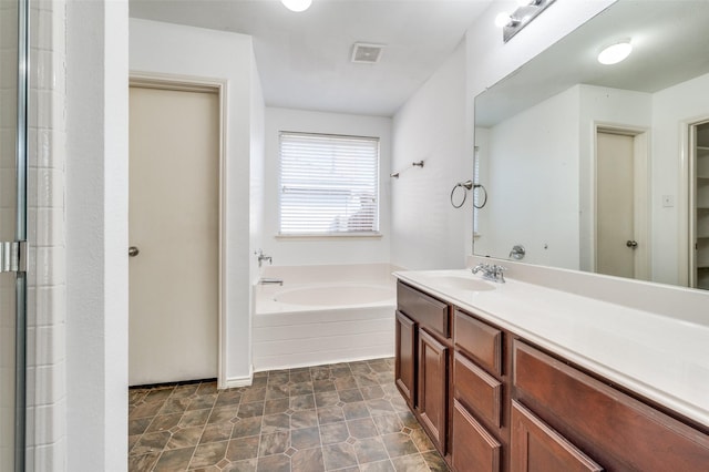 bathroom with an enclosed shower, visible vents, a bath, and vanity