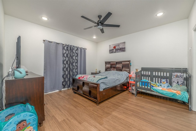 bedroom featuring ceiling fan and light hardwood / wood-style floors