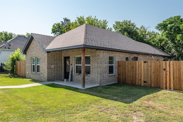 view of front of home with a front lawn and a patio