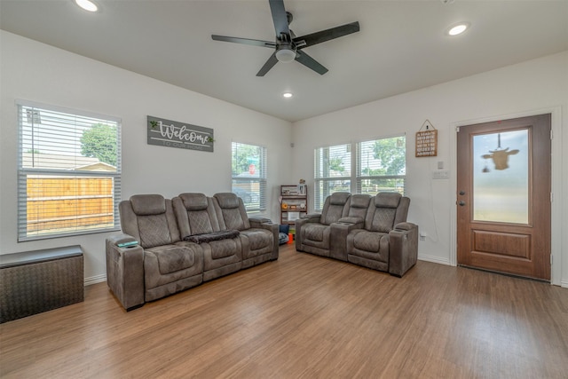 living room with ceiling fan and light hardwood / wood-style floors