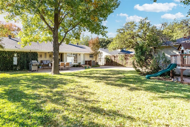 view of yard featuring an outdoor living space, a patio, and a playground