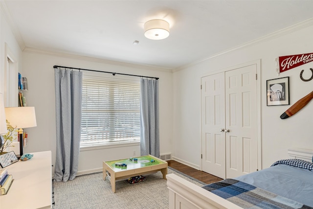 bedroom featuring ornamental molding and hardwood / wood-style floors