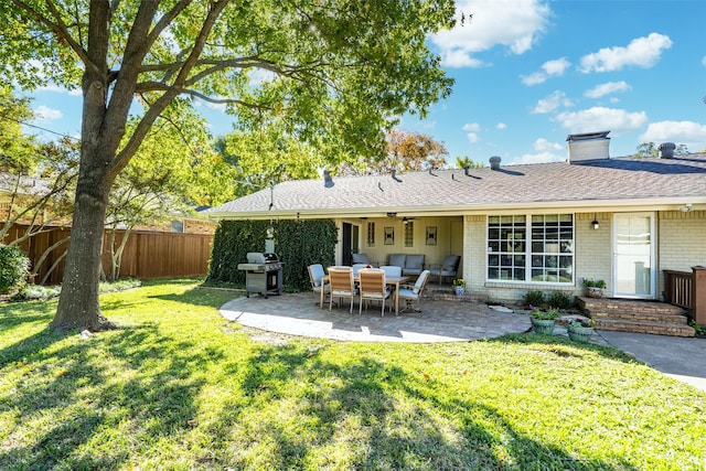 rear view of property featuring a yard and a patio