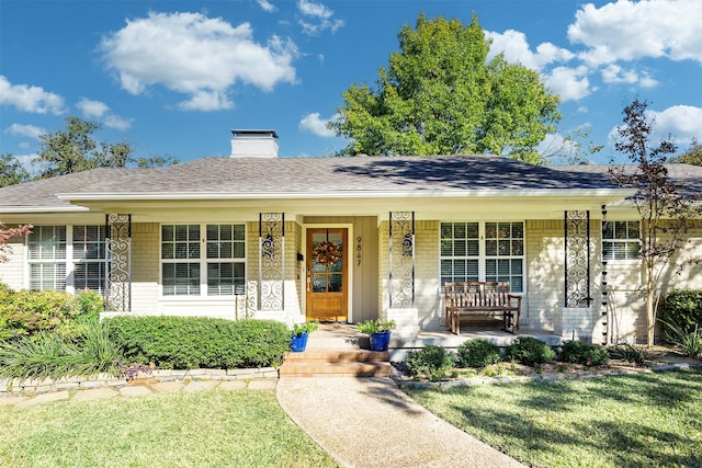 ranch-style home with a front lawn and a porch