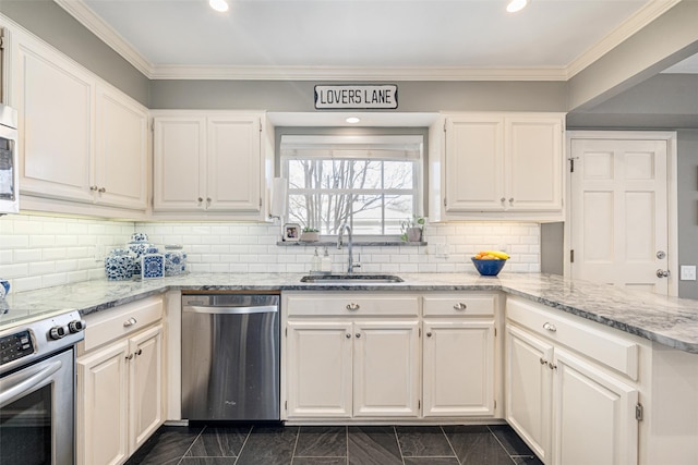 kitchen with tasteful backsplash, appliances with stainless steel finishes, light stone countertops, and sink