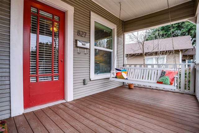 wooden terrace featuring covered porch