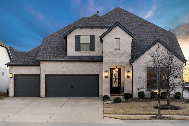 french provincial home with a garage