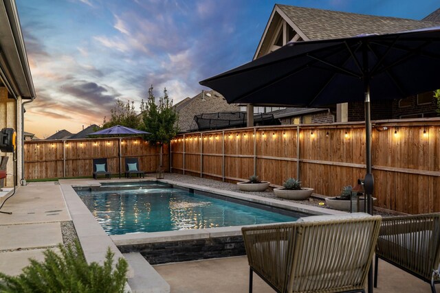 view of pool with an outdoor living space, a patio, a grill, and a hot tub