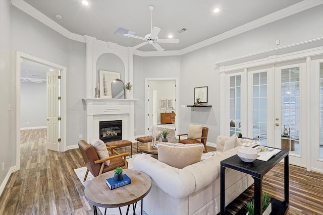 living room with crown molding, hardwood / wood-style flooring, and ceiling fan