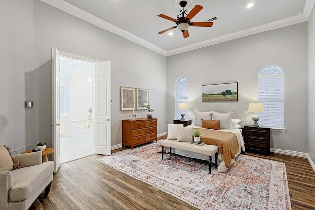 bedroom with baseboards, crown molding, visible vents, and wood finished floors