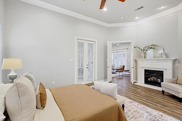 bedroom with hardwood / wood-style flooring, access to outside, ceiling fan, crown molding, and french doors