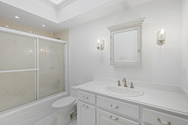 full bathroom featuring vanity, crown molding, shower / bath combination with glass door, and toilet