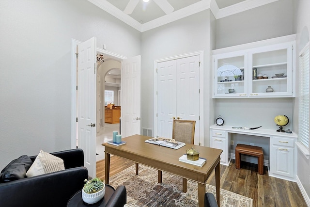 home office with visible vents, arched walkways, a ceiling fan, dark wood-style flooring, and crown molding