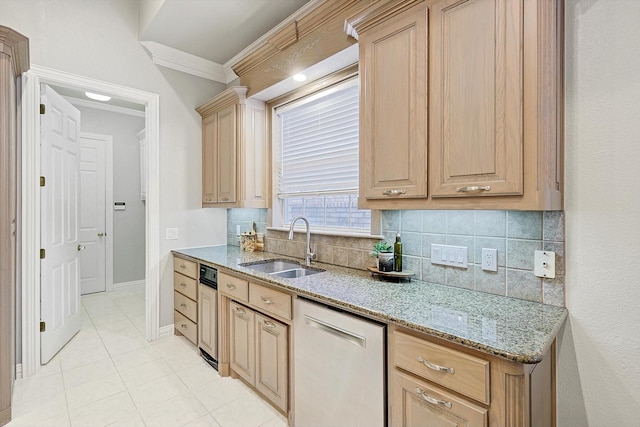 kitchen with light stone counters, backsplash, light brown cabinets, a sink, and dishwasher