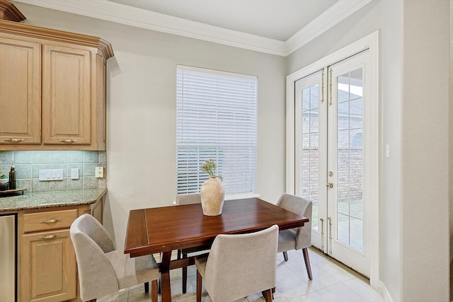 dining area with crown molding and french doors