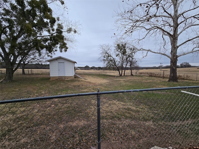 view of yard with a storage unit and a rural view