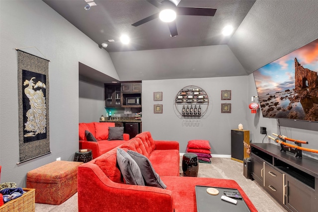 home theater with lofted ceiling, a textured ceiling, light colored carpet, and ceiling fan