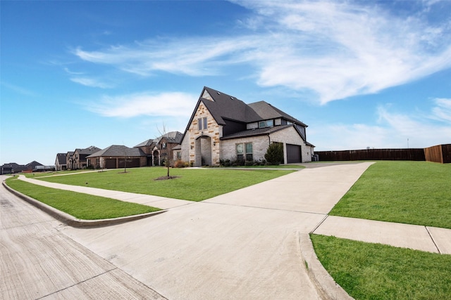 view of front of home featuring a garage and a front lawn