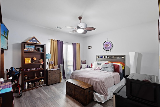 bedroom with ceiling fan and light wood-type flooring