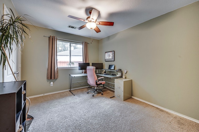 carpeted office space featuring ceiling fan