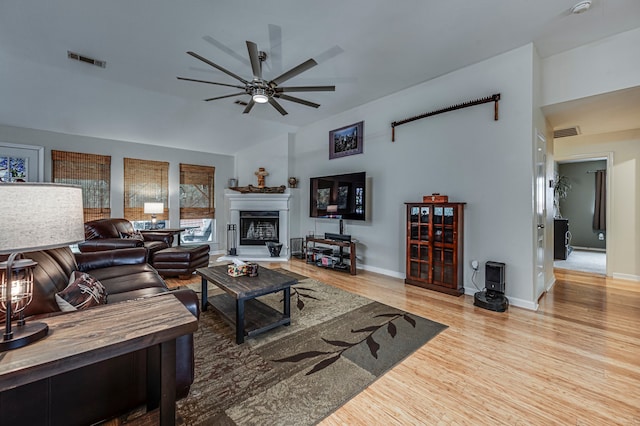 living room featuring light hardwood / wood-style flooring and ceiling fan