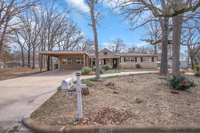 ranch-style home featuring a carport