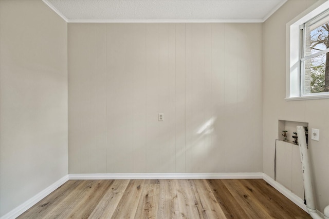 washroom featuring ornamental molding, washer hookup, and light wood-type flooring