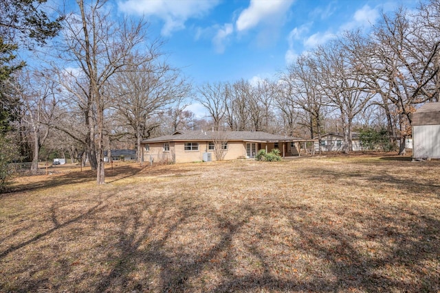 back of house with a lawn