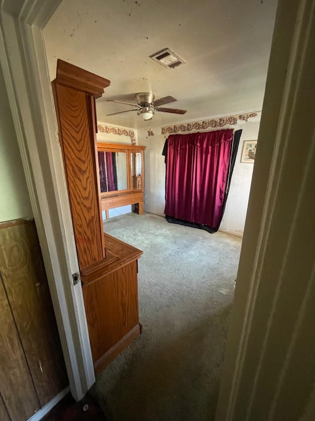 unfurnished bedroom with carpet flooring and ceiling fan