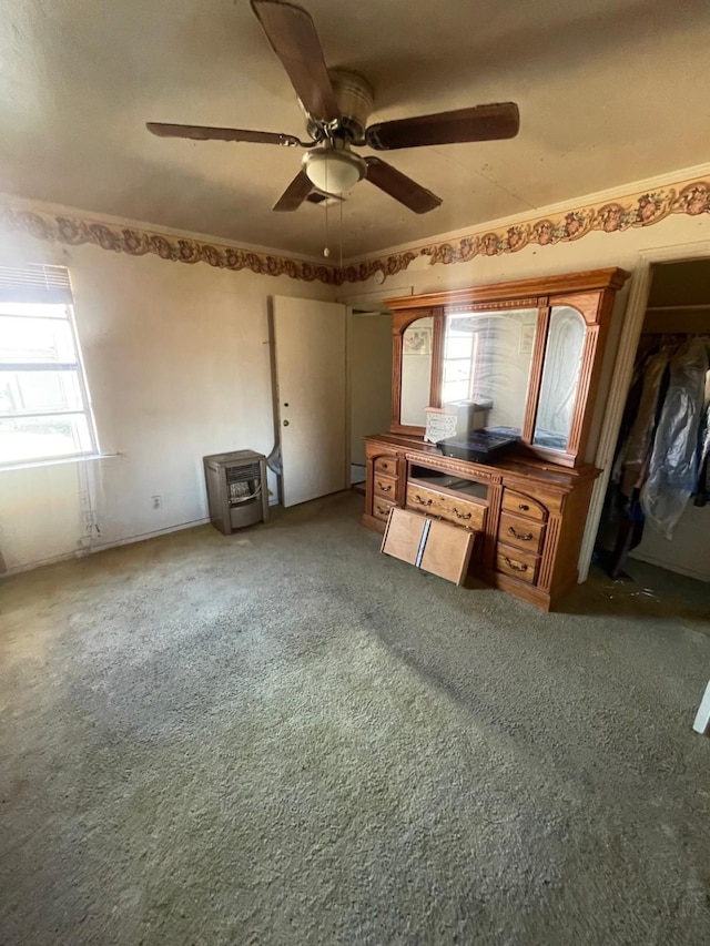 unfurnished office featuring ceiling fan and carpet flooring